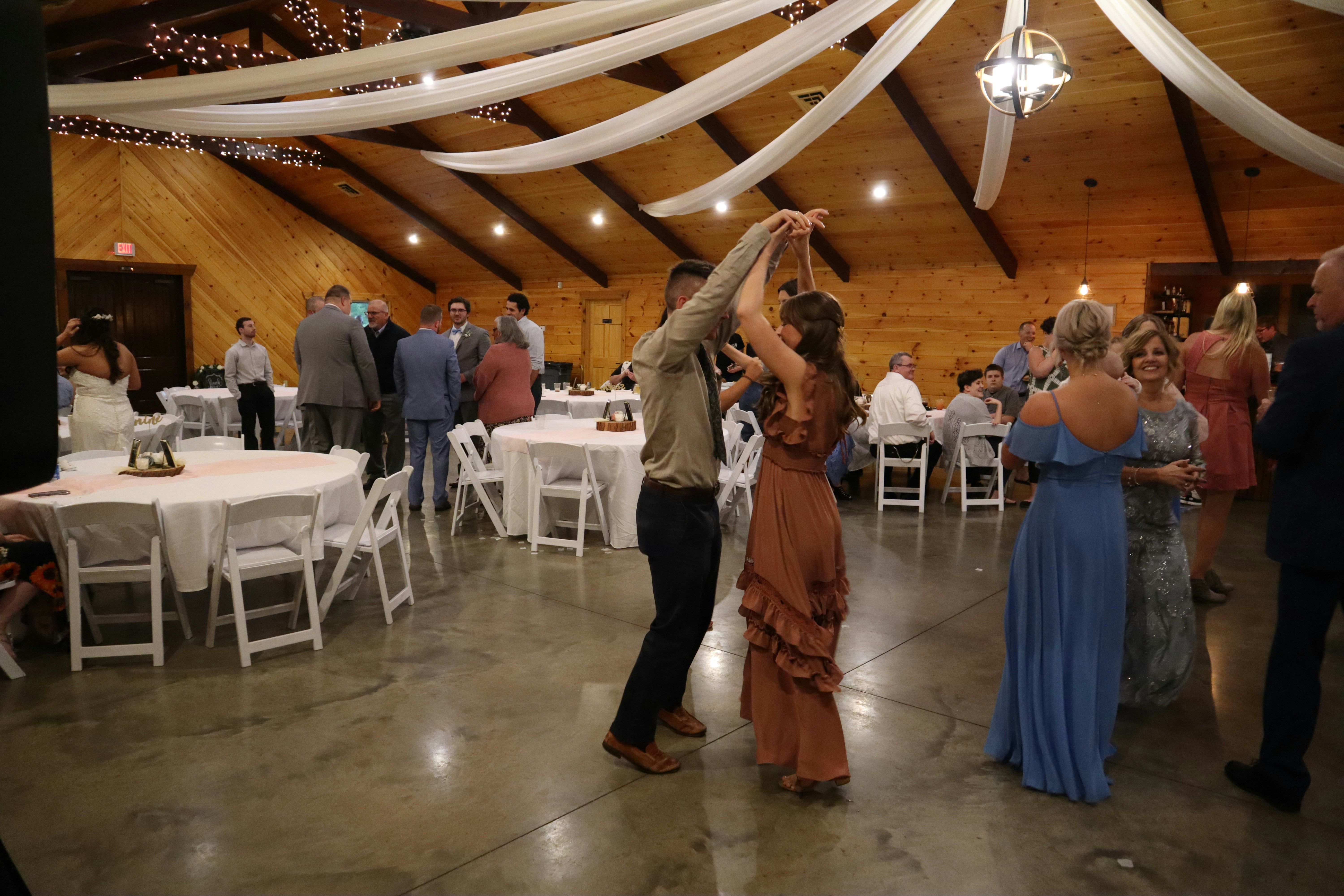 Couple dancing at a barn wedding reception