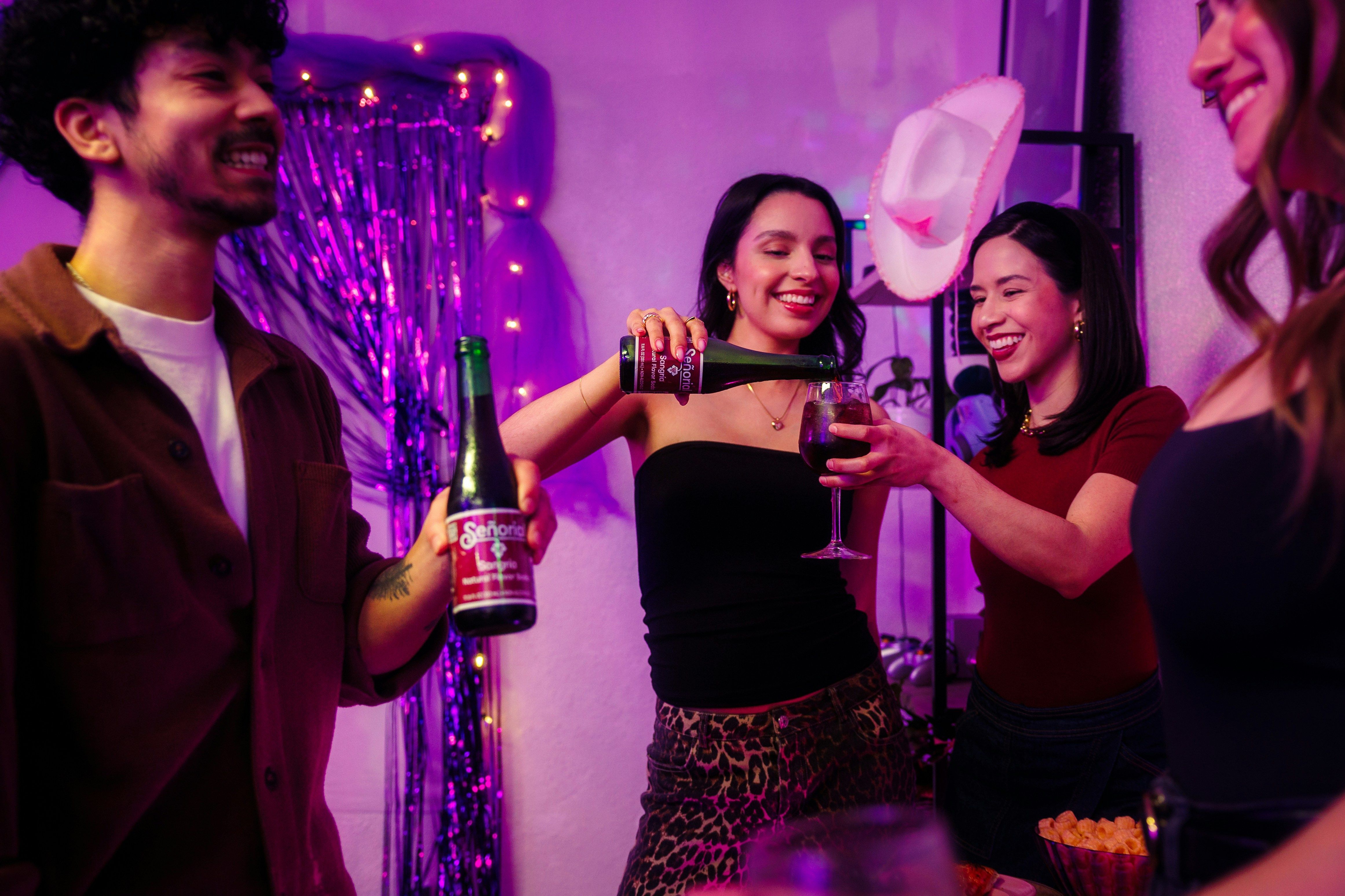 Friends celebrating with cowboy hats and drinks